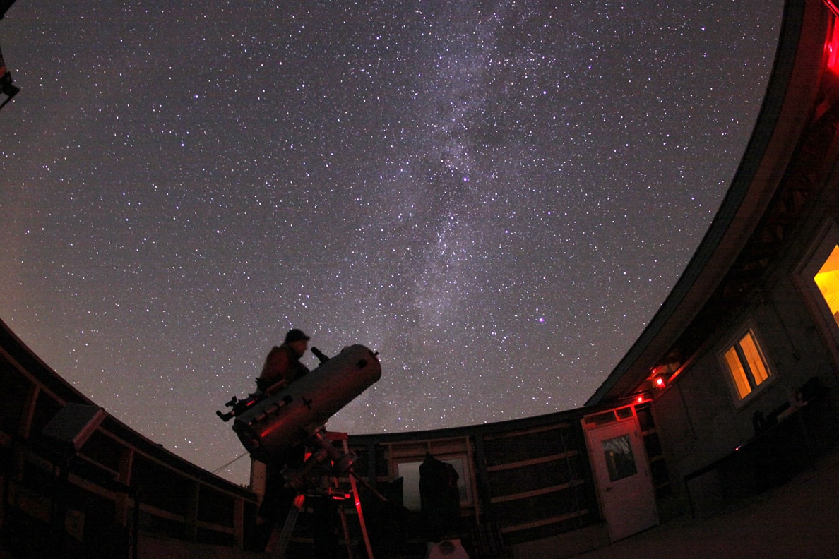 man using telescope