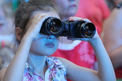 Girl at concert with binoculars