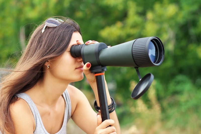 Girl looking through spotting scope