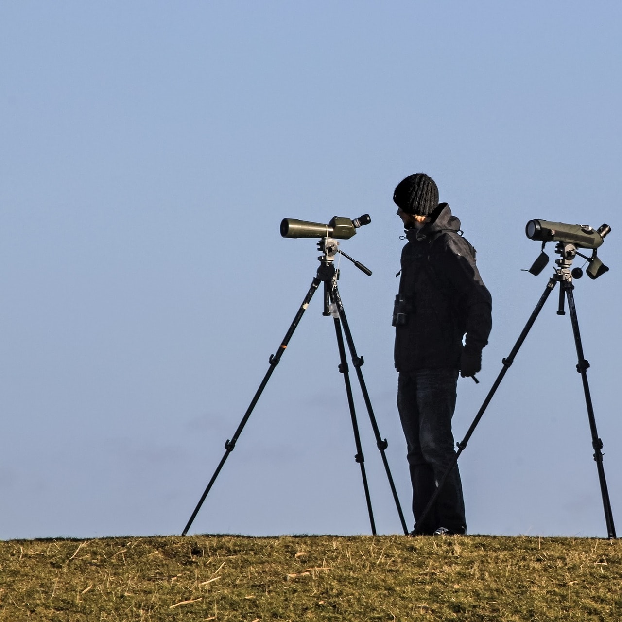 man using spotting scope