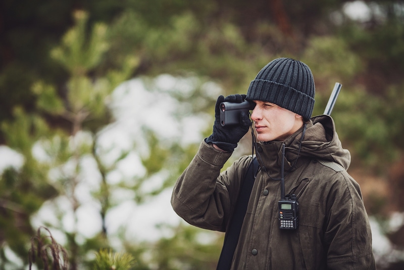 Man hunter using rangefinder