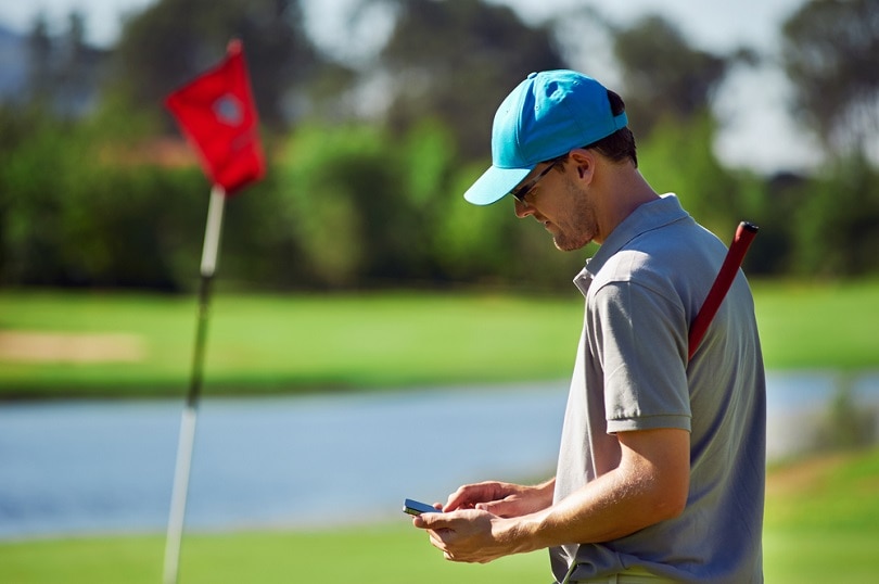 golf man with smart phone gps device_Daxiao Productions_shutterstock