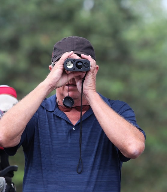golfer uses a measuring device_Ron Alvey_shutterstock