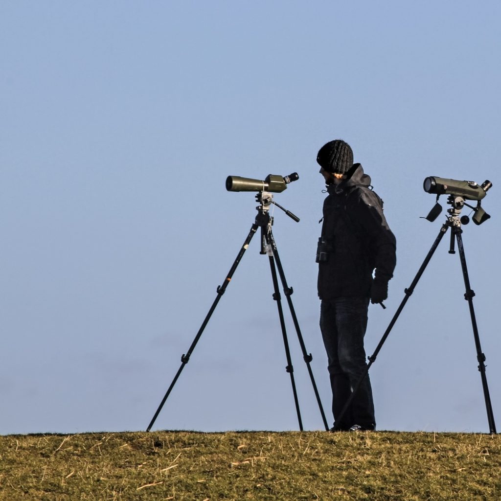 man with spotting scopes