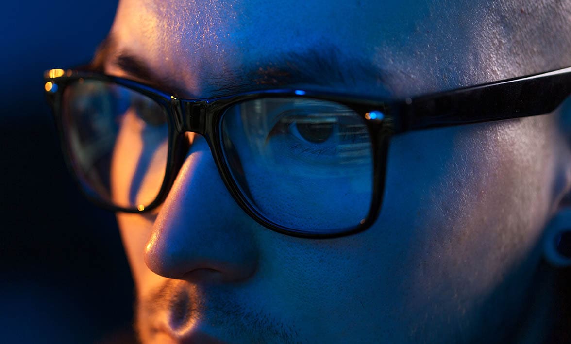man wearing blue light glasses