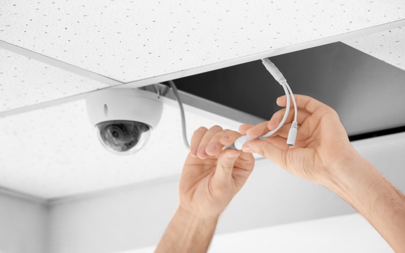 man installing indoor CCTV