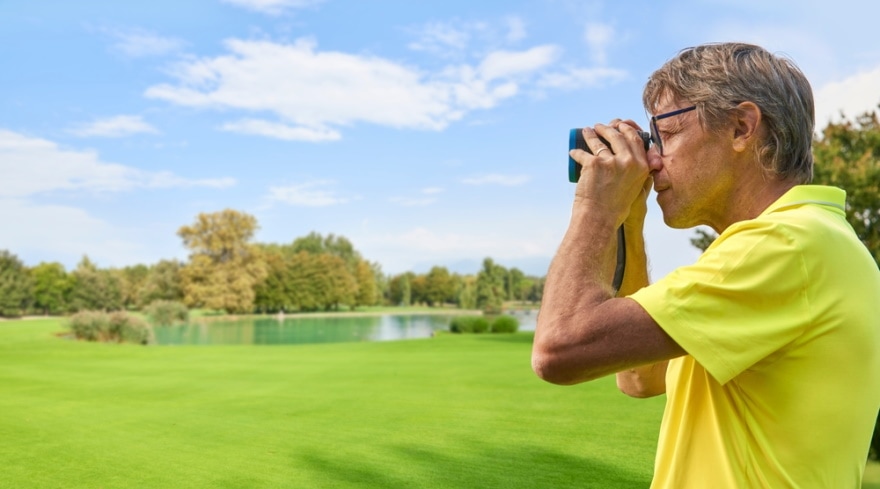 golf player using Rangefinder in the field