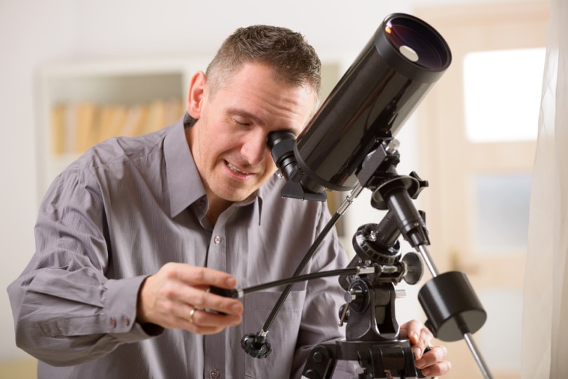 man using telescope