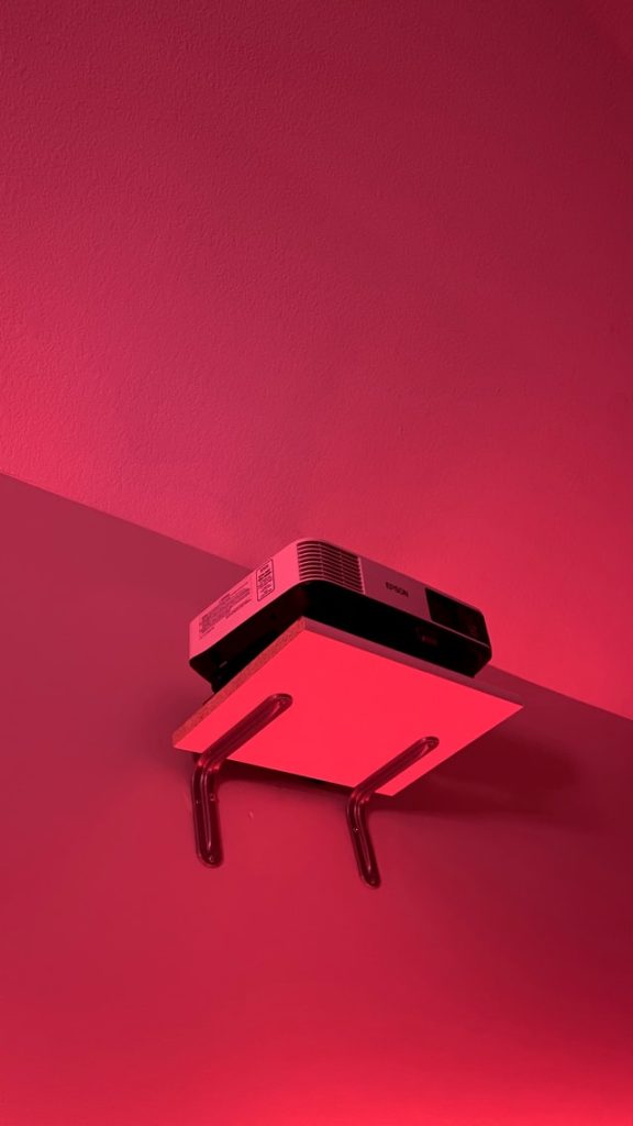projector on a wall mounted shelf