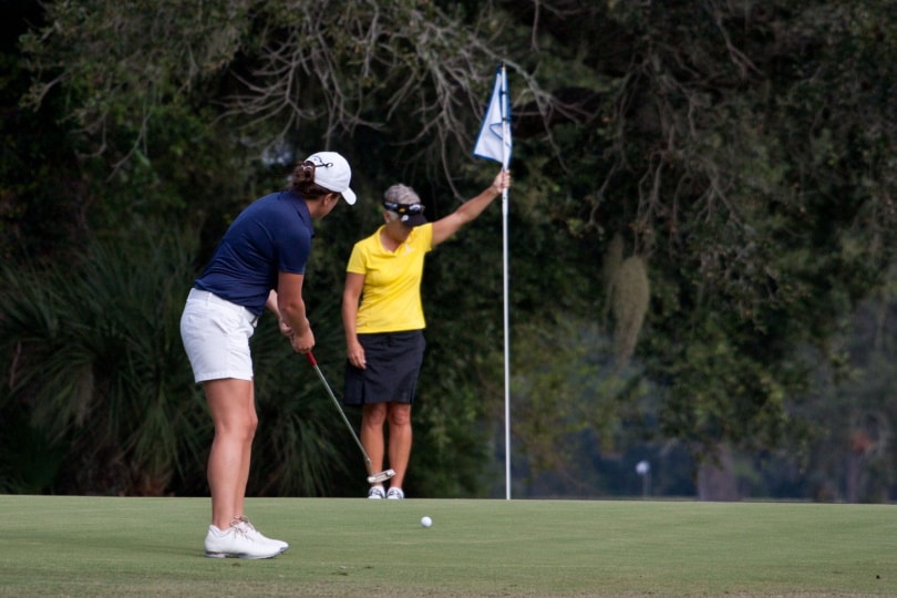two woman playing golf