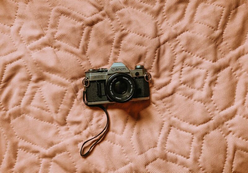 canon camera 35mm on the bed