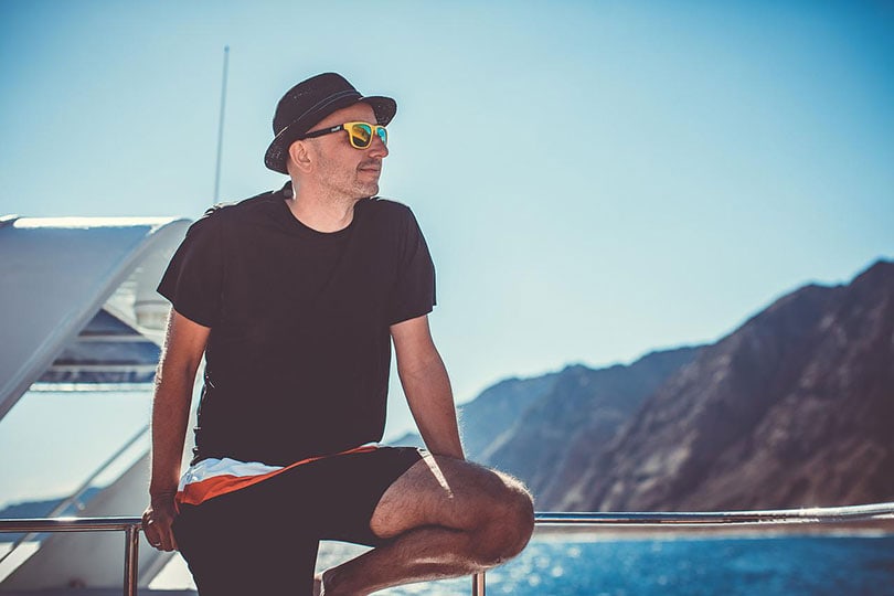 man on a yacht wearing sunglasses