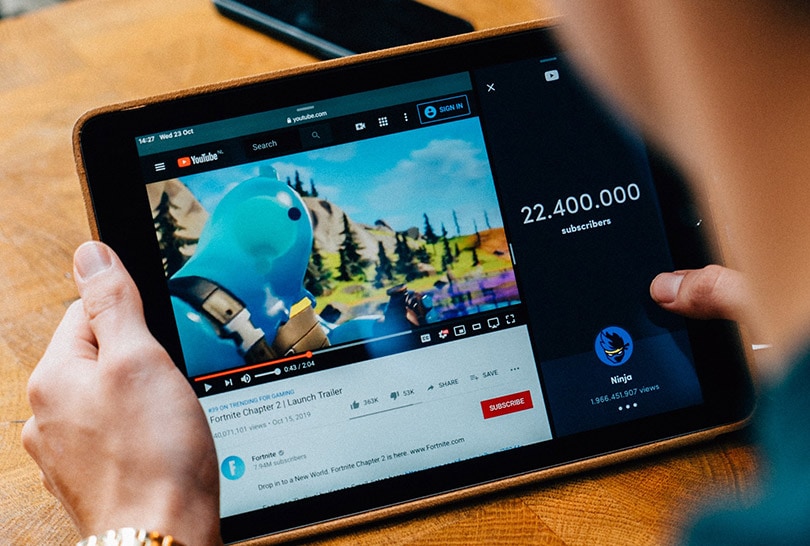 man watching yyoutube on his tablet