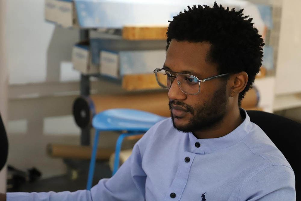 man wearing glasses while working