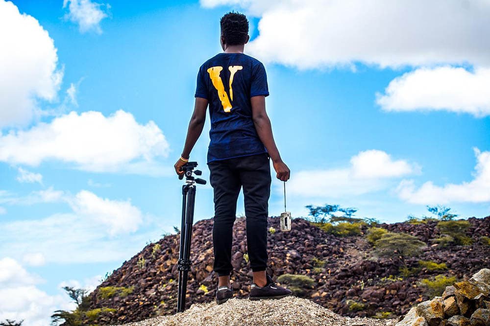 man went hiking with tripod and camera
