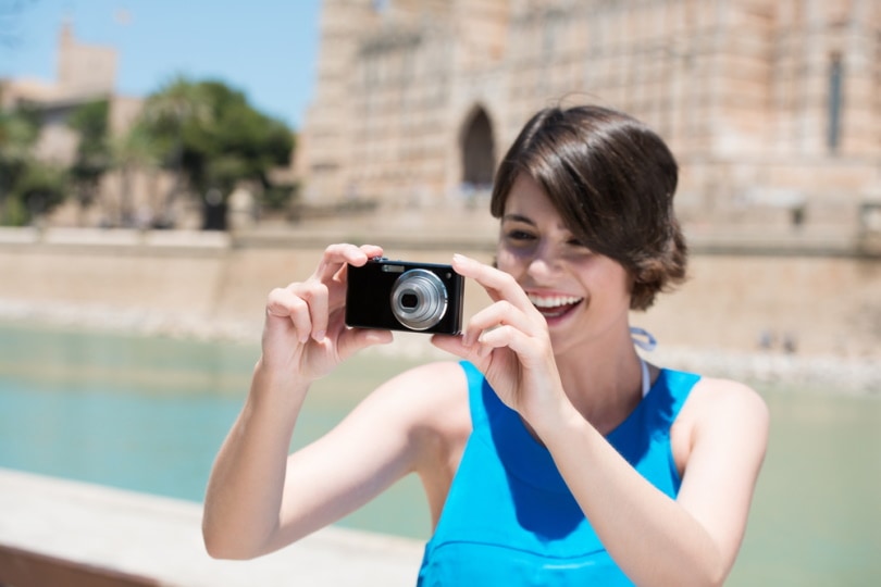woman using point and shoot camera