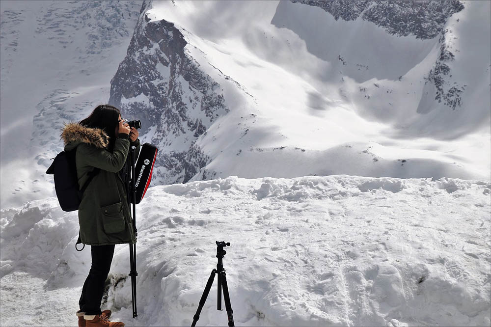 woman went hiking during winter with tripods and camera