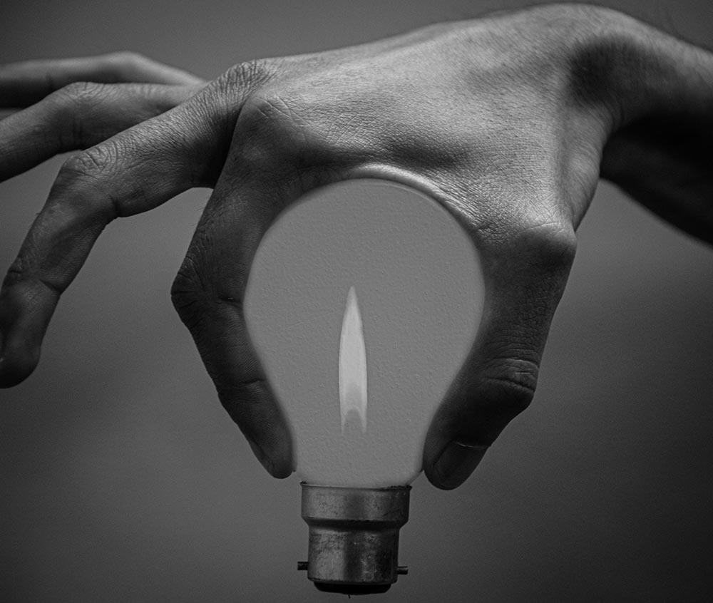 black and white hand shaped into bulb