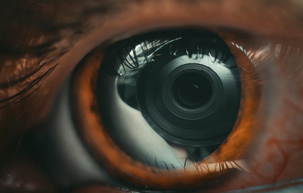 camera lens reflecting on a person's eye