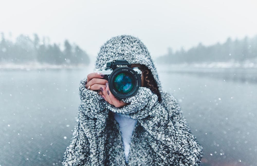 female photographer taking photos during winter
