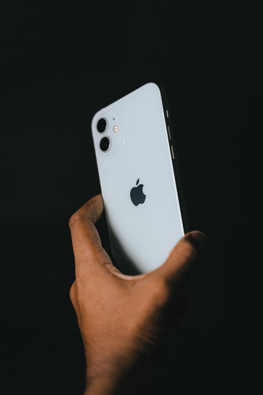 hand holding white iphone