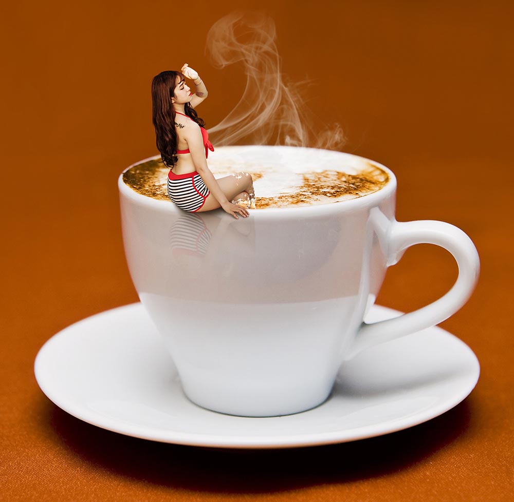 lady in bikini seating on a cup of coffee