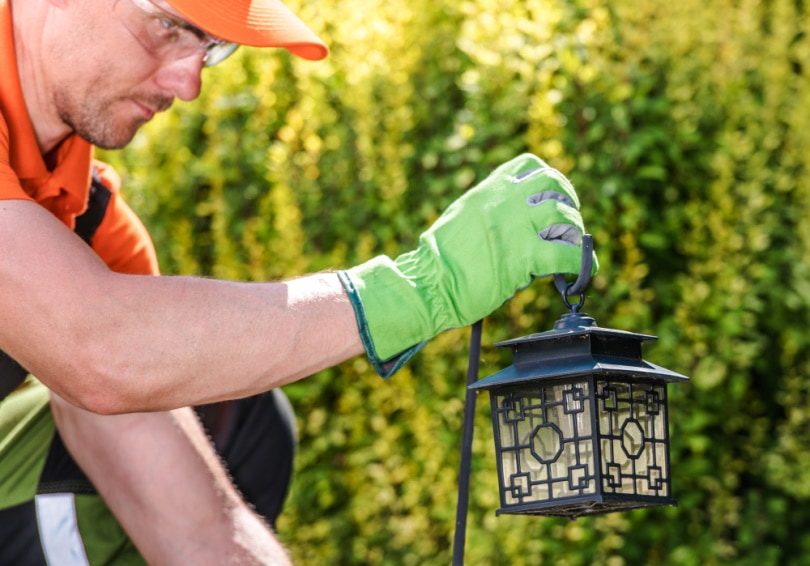 man installing hanging lantern