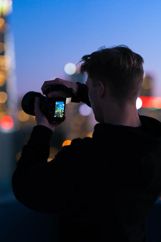 man taking photos at night