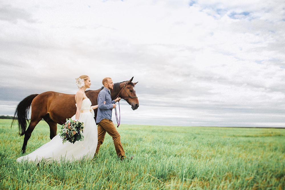 newly wed couple and their horse