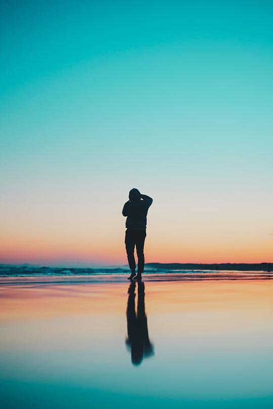 person's silhouette reflecting on the water
