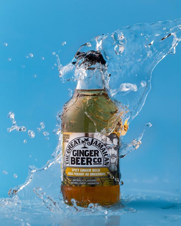 photograph of a bottle of ginger beer with water splash effect