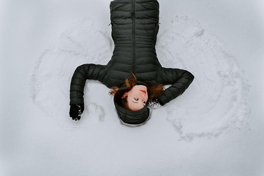 woman creating a snow angel