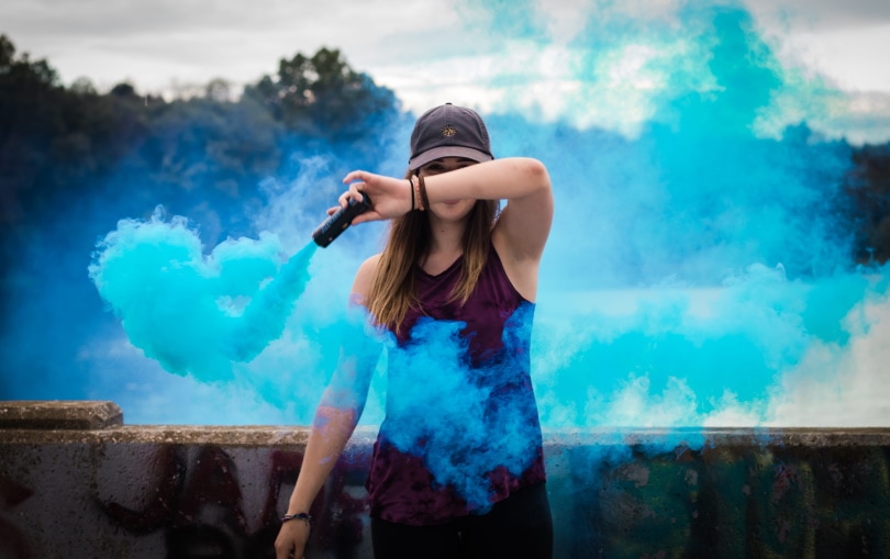 woman holding smoke flare