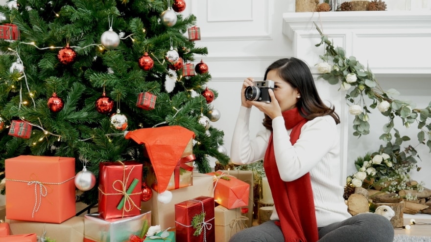 woman taking photo of christmas tree