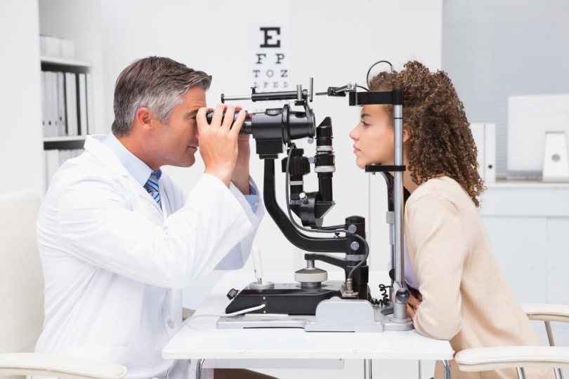Woman doing eye test with optometris