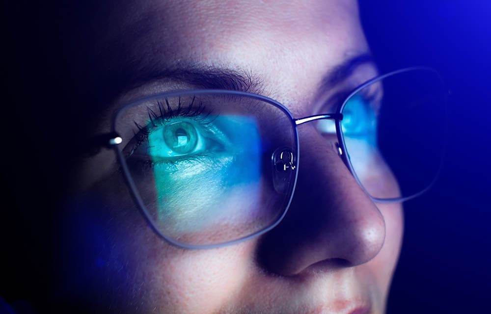 close up woman wearing blue light glasses