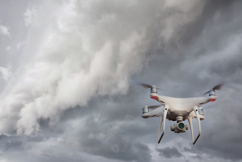 drone flying in front of dark storm clouds