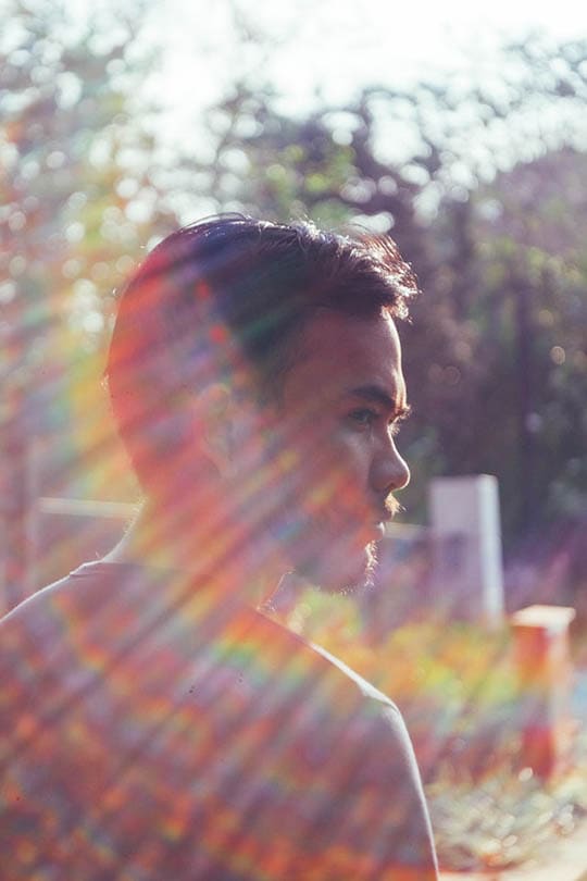 man looking on the side with lens flare