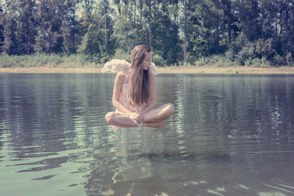 woman with wings floating in the water