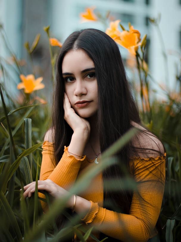 young woman in the middle of tall plants