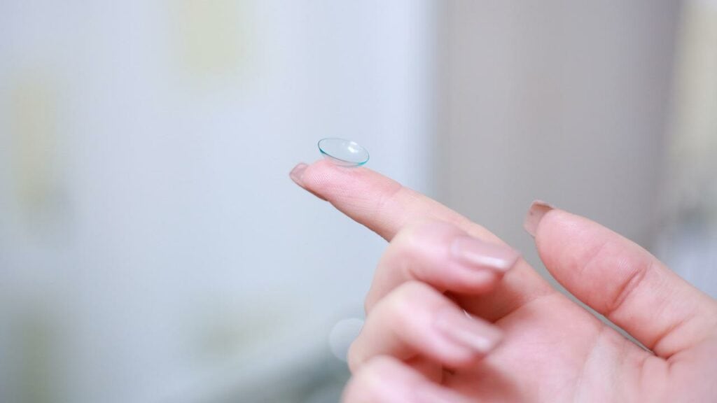 contact lens on a woman's finger