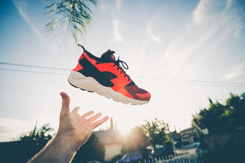 hand throwing shoe into the air