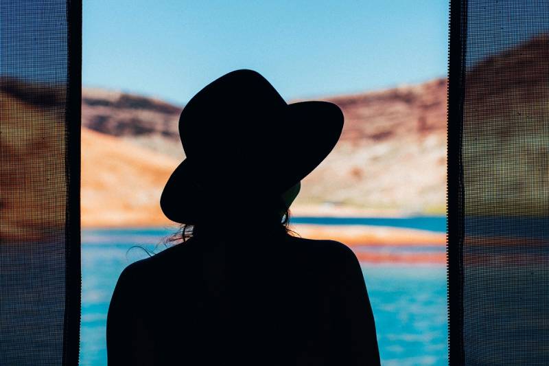 silhouette of a woman wearing a hat