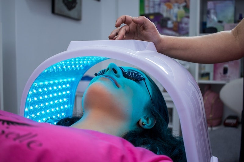 Woman undergoing UV beauty treatment