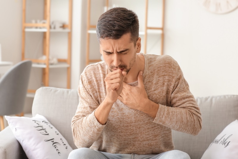man coughing