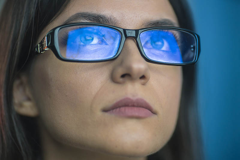 woman wearing blue light eyeglasses