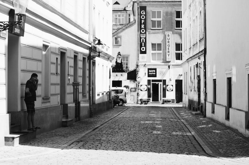 Man in grayscale city backdrop
