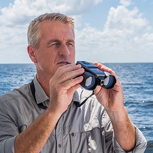 man holding Atomic Beam Night Hero Binoculars