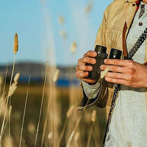 person using Nocs Provisions Standard Issue Waterproof Binoculars