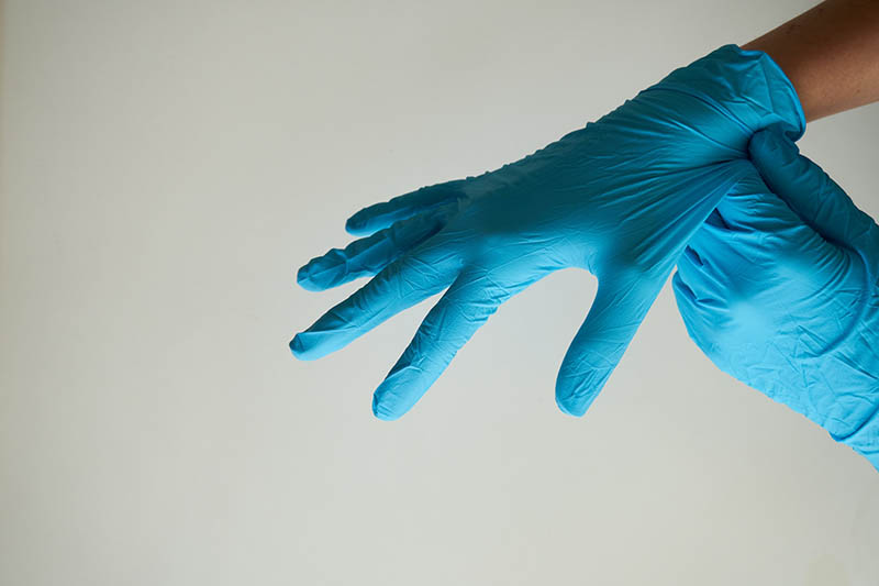 person putting gloves